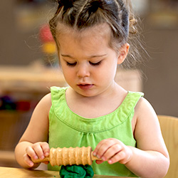 girl playing with play doh in class