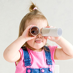 girl looking through pretend binoculars