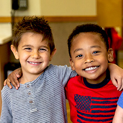 two boys smiling arm around each other