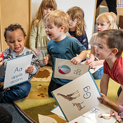 group of kids holding letter cards