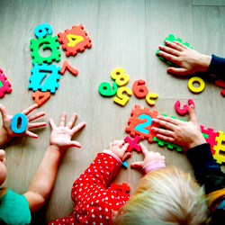 kids playing with colorful foam numbers