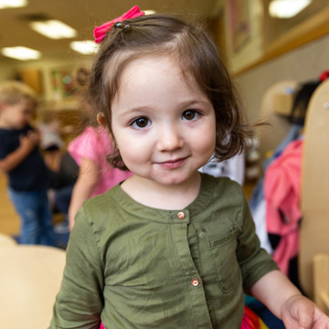 little girl smiling green shirt